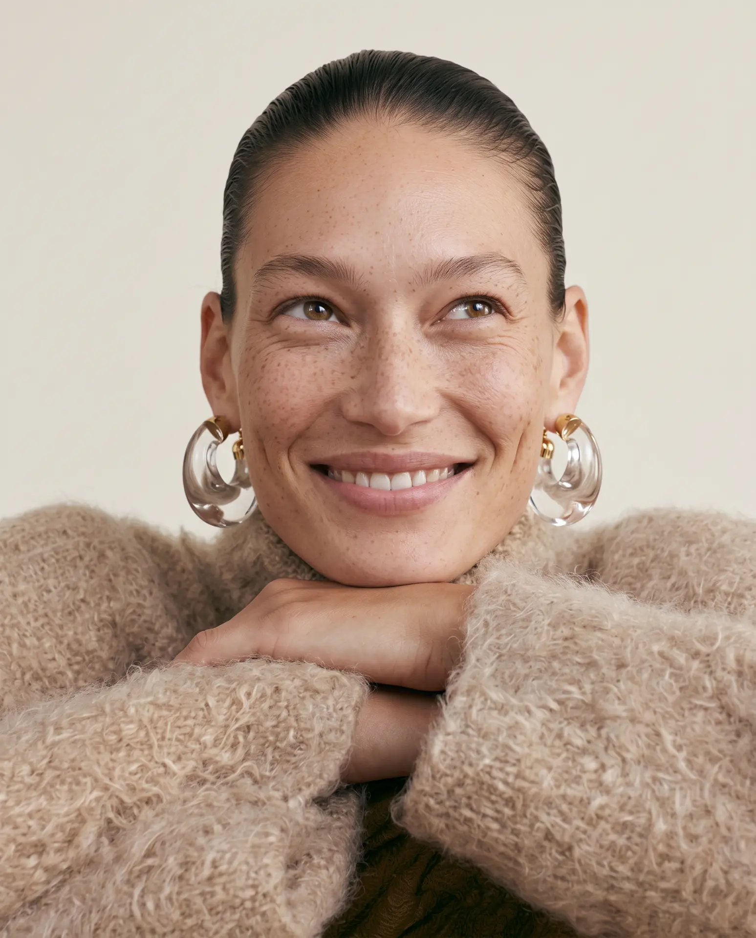Editorial beauty portrait, smiling model with statement earrings, AI-generated imagery